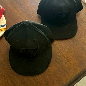 Lot of two all black buccaneers hats one snap back one 7 1/2 fitted